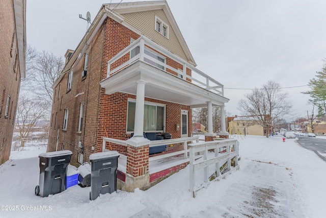 exterior space featuring a porch and a balcony