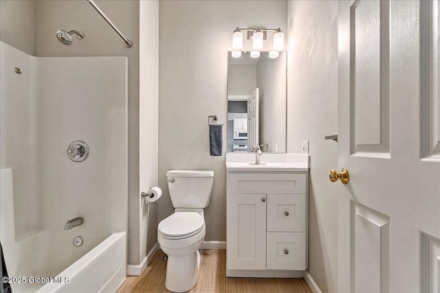 full bathroom with hardwood / wood-style flooring, shower / washtub combination, toilet, and vanity