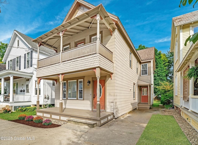 view of front facade featuring a balcony and a porch