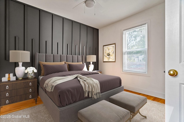 bedroom with light hardwood / wood-style flooring and ceiling fan