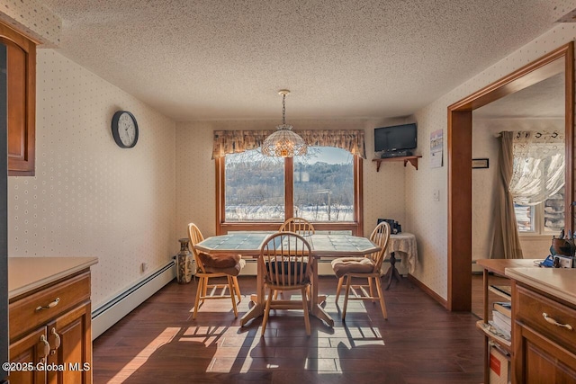 dining space featuring dark wood-type flooring, a textured ceiling, and baseboard heating