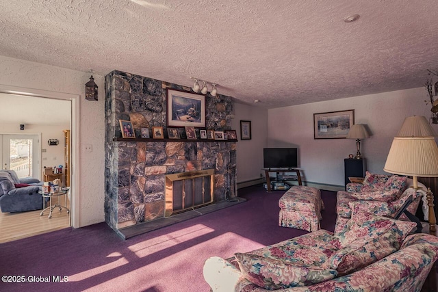 carpeted living room featuring a stone fireplace and a textured ceiling