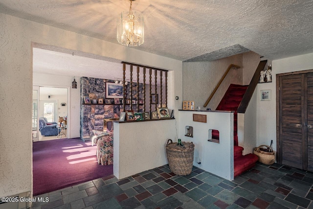 foyer entrance featuring a chandelier and a textured ceiling