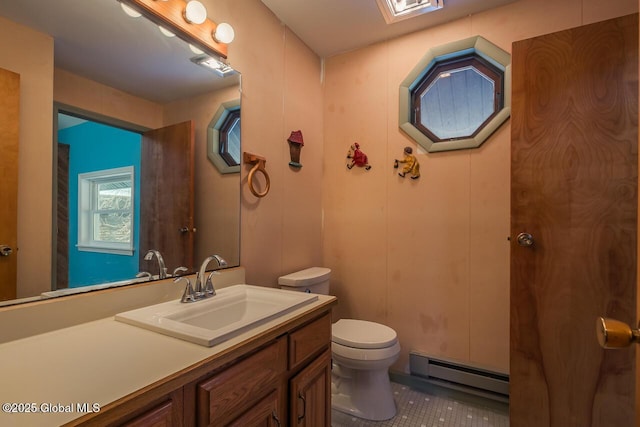 bathroom with vanity, a baseboard heating unit, tile patterned flooring, and toilet