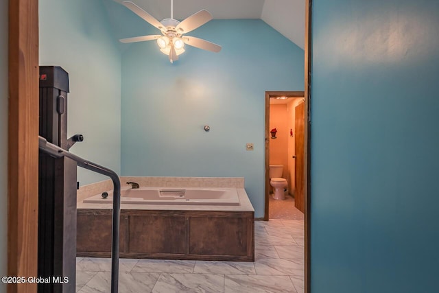 bathroom with sink, ceiling fan, a tub to relax in, vaulted ceiling, and toilet