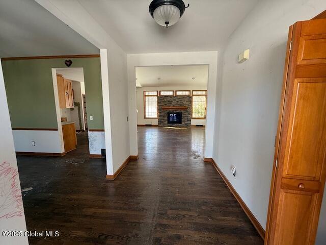 corridor with ornamental molding and dark hardwood / wood-style flooring