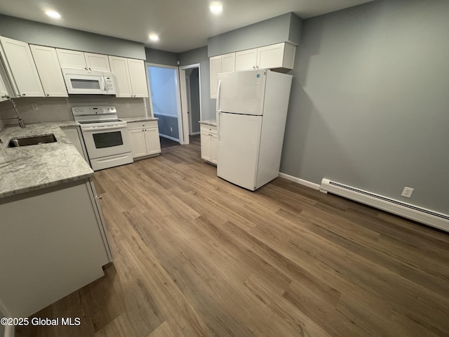 kitchen with sink, white cabinetry, white appliances, light stone countertops, and light hardwood / wood-style floors