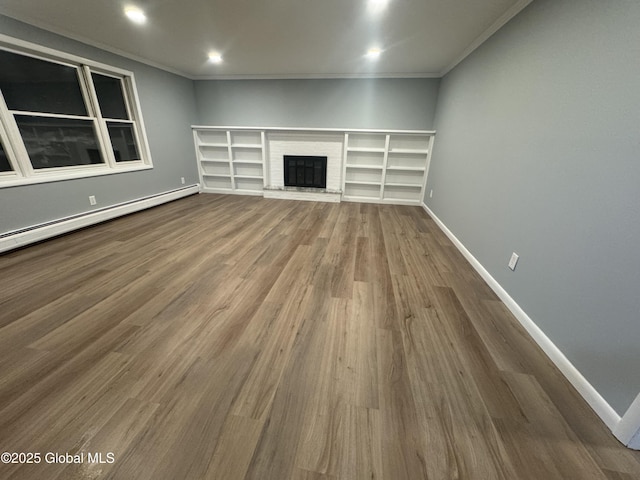 unfurnished living room featuring a baseboard heating unit, hardwood / wood-style flooring, a fireplace, and ornamental molding