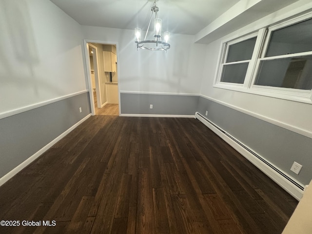 unfurnished dining area with dark hardwood / wood-style floors, a chandelier, and a baseboard heating unit