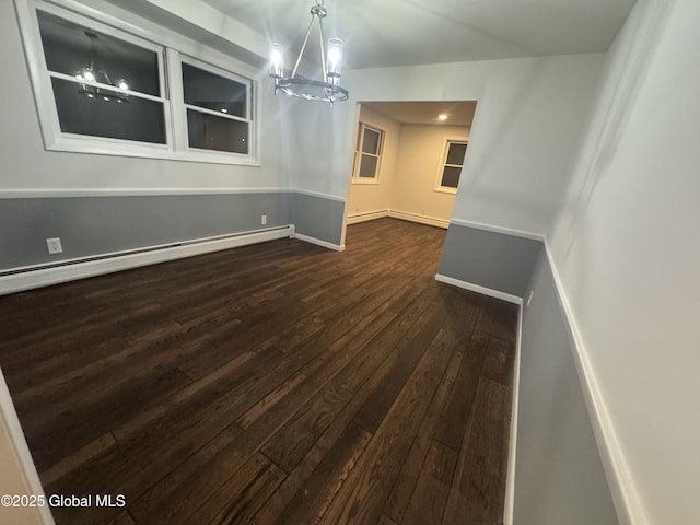 unfurnished dining area with a baseboard radiator, dark wood-type flooring, and an inviting chandelier