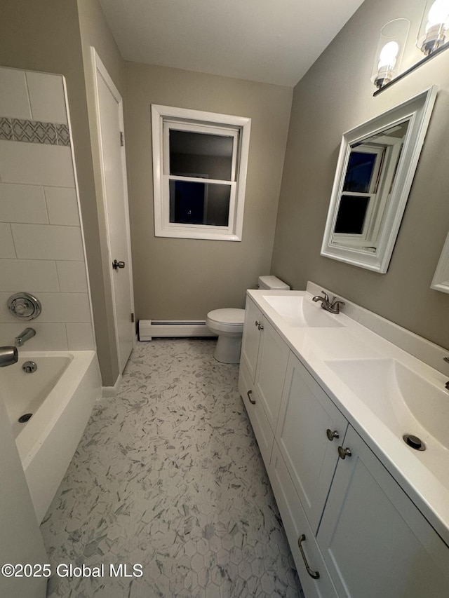 full bathroom featuring vanity, tiled shower / bath combo, toilet, and baseboard heating