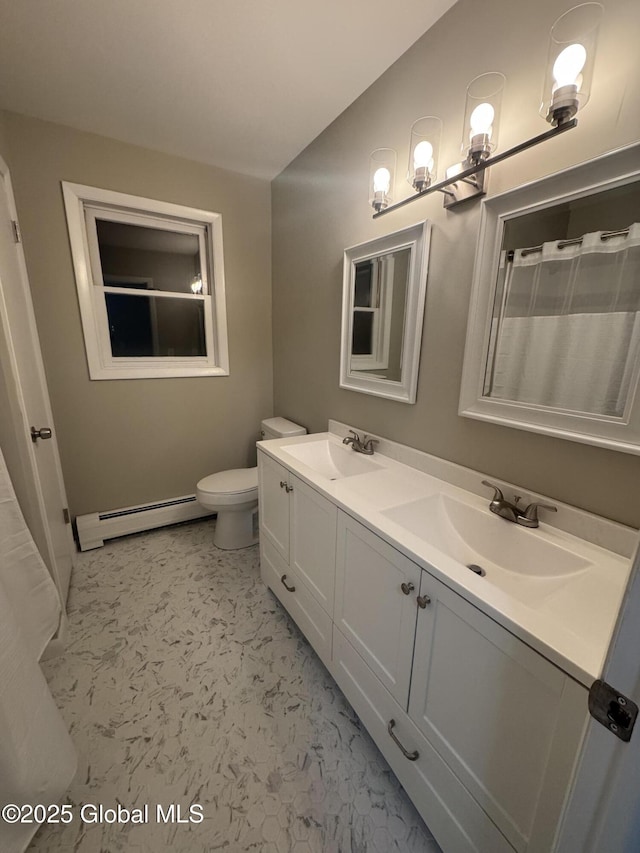 bathroom with vanity, toilet, and a baseboard heating unit