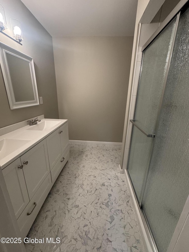 bathroom featuring walk in shower and vanity