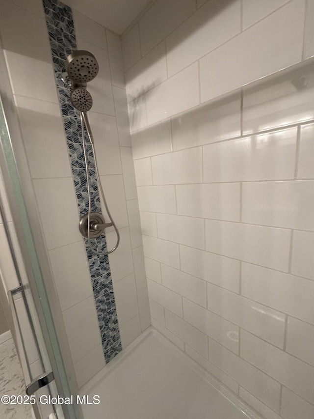 bathroom with tiled shower