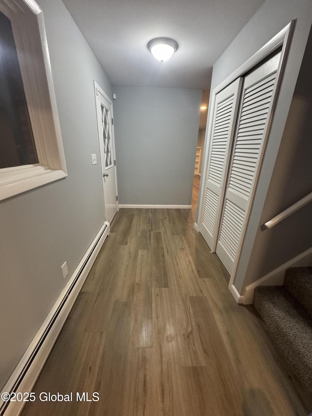 hall with hardwood / wood-style flooring and a baseboard radiator