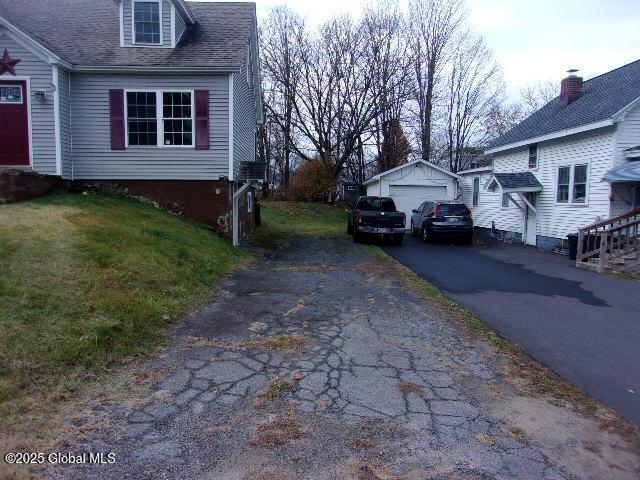 view of home's exterior featuring a garage and an outbuilding