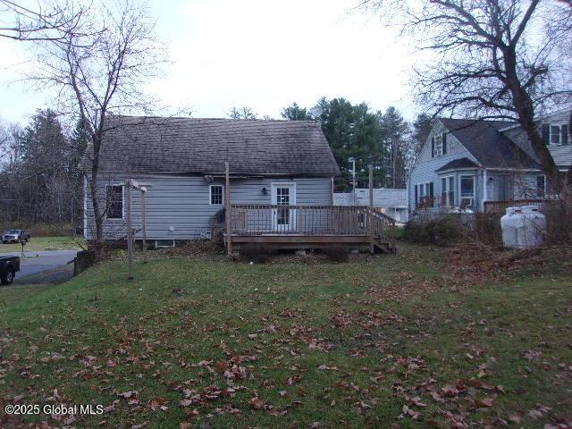 back of house featuring a yard and a deck
