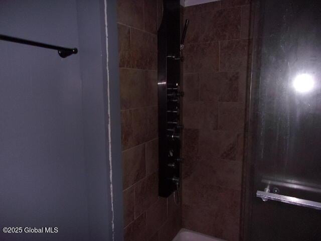 bathroom with a tile shower