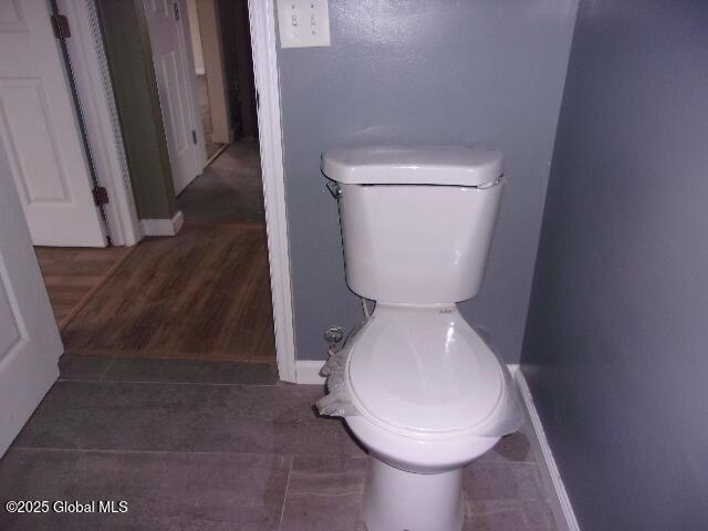 bathroom featuring toilet and tile patterned flooring