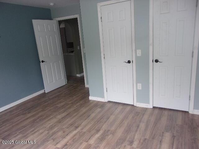 unfurnished bedroom with hardwood / wood-style floors