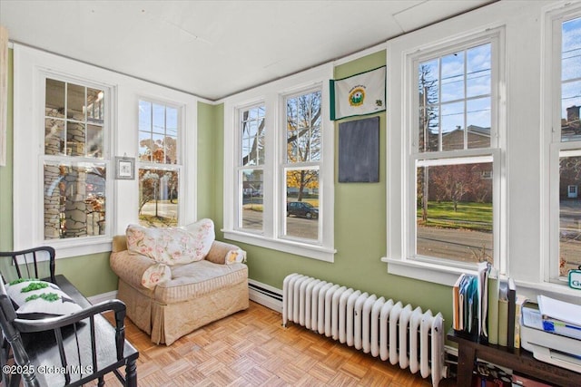 sunroom featuring radiator and plenty of natural light