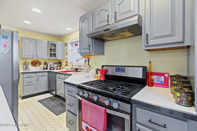 kitchen with appliances with stainless steel finishes, sink, and gray cabinetry