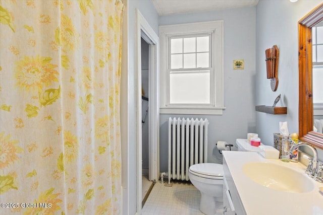 bathroom featuring tile patterned floors, vanity, toilet, and radiator