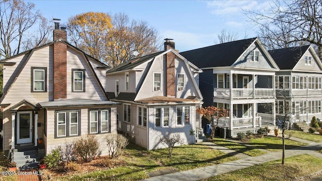 rear view of property featuring a yard