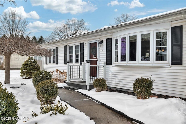 view of snow covered property entrance