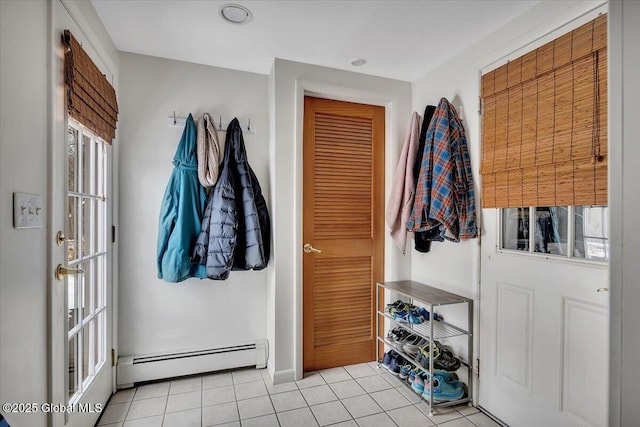 mudroom with light tile patterned floors and a baseboard heating unit