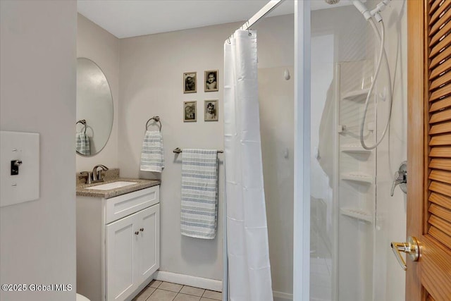 bathroom featuring vanity, tile patterned floors, and walk in shower