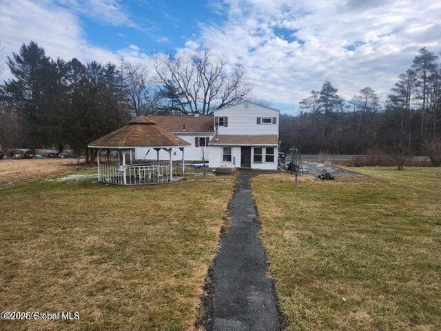 view of front of property with a gazebo and a front yard