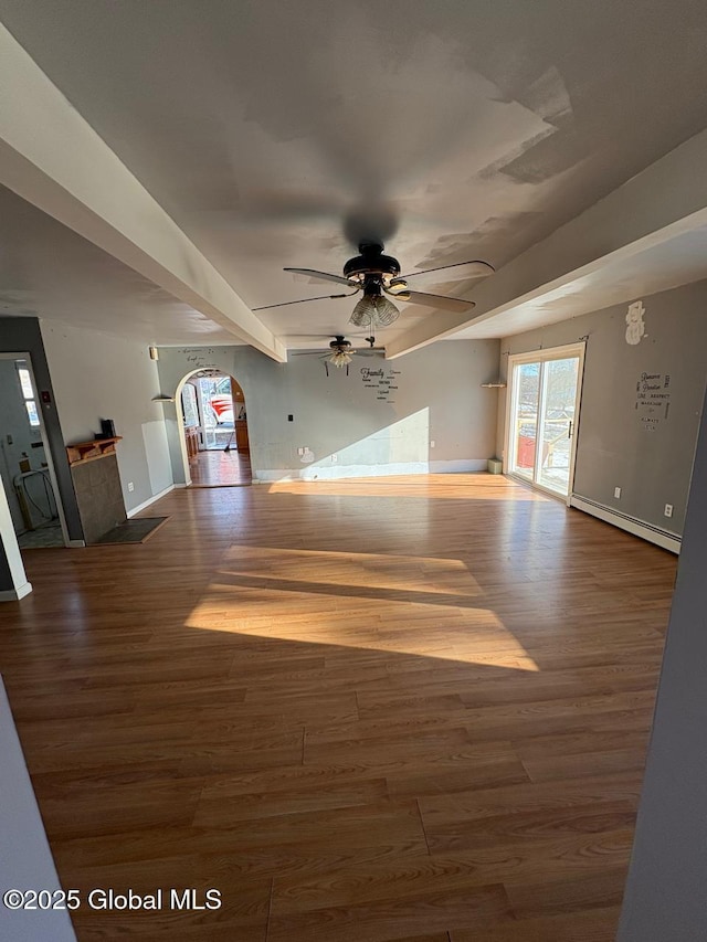 unfurnished living room with hardwood / wood-style flooring, ceiling fan, and a baseboard heating unit