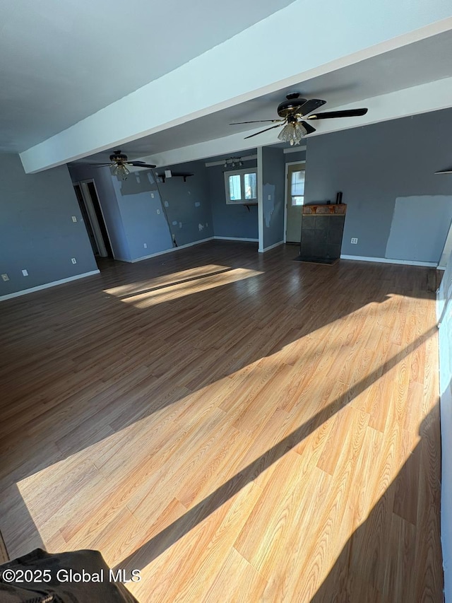 unfurnished living room featuring hardwood / wood-style floors and ceiling fan