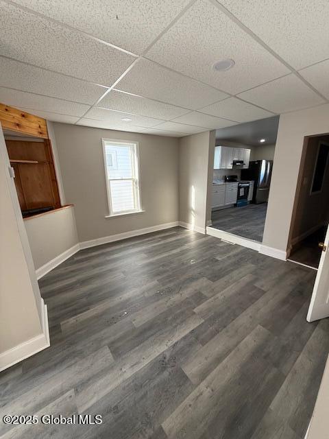 interior space featuring dark hardwood / wood-style floors and a paneled ceiling