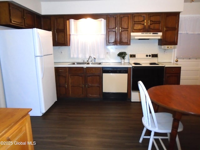 kitchen featuring a sink, white appliances, under cabinet range hood, and light countertops