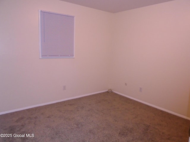 carpeted spare room with baseboards