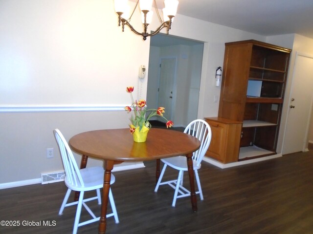 dining room featuring a chandelier, visible vents, baseboards, and dark wood-style flooring