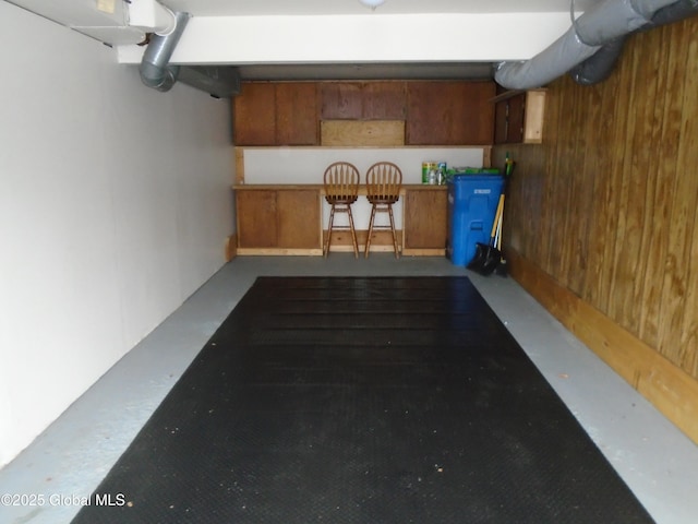 garage featuring wood walls