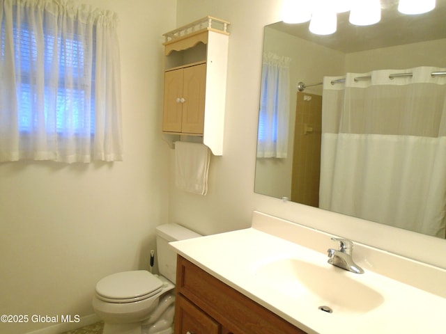 bathroom with a shower with shower curtain, toilet, and vanity