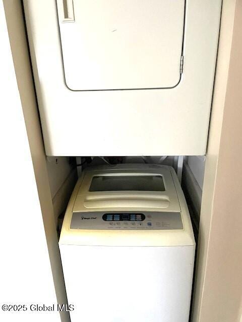 washroom featuring laundry area and stacked washing maching and dryer