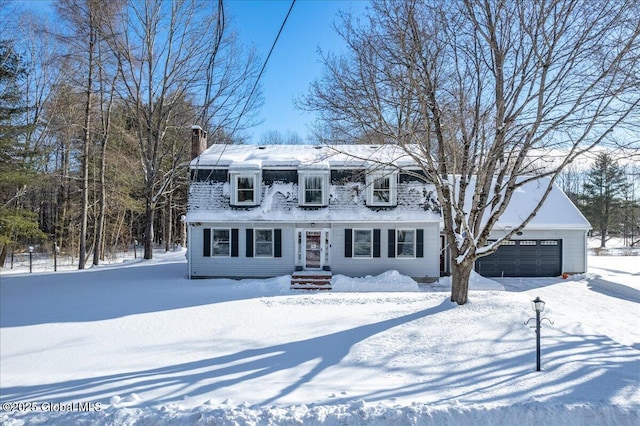 cape cod home featuring a garage