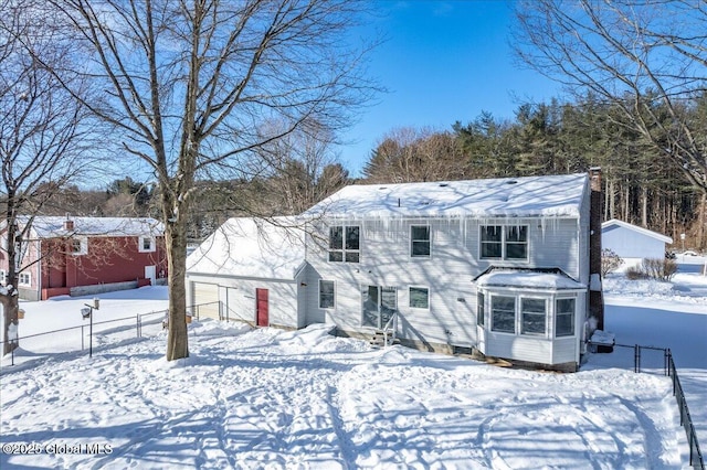 view of snow covered back of property