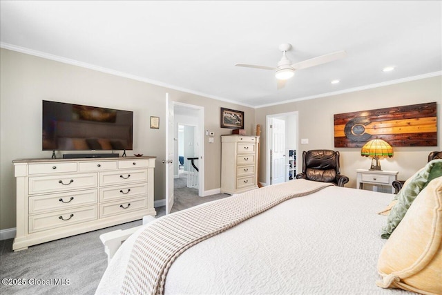 carpeted bedroom with ornamental molding and ceiling fan