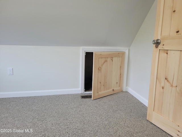 bonus room with baseboards, vaulted ceiling, and carpet floors