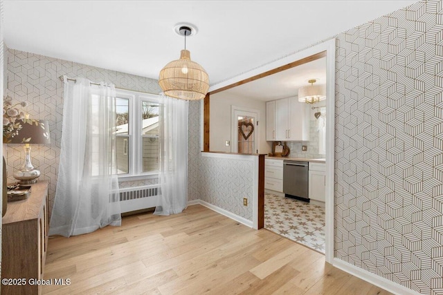 dining room featuring radiator and light hardwood / wood-style floors