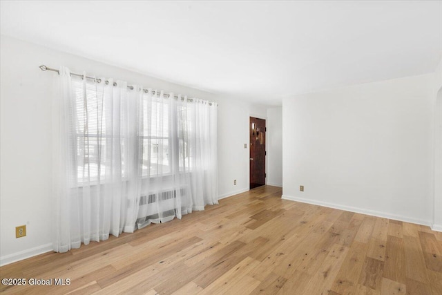 empty room with light hardwood / wood-style flooring