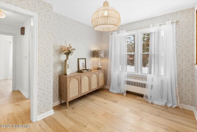 interior space featuring radiator and light hardwood / wood-style flooring