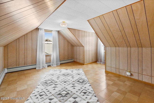 bonus room with baseboard heating, vaulted ceiling, and wood walls