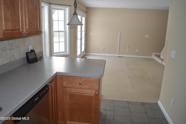 kitchen featuring pendant lighting, decorative backsplash, light colored carpet, and dishwasher